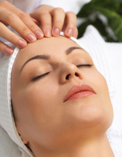 pretty woman getting facial massage in the beauty salon